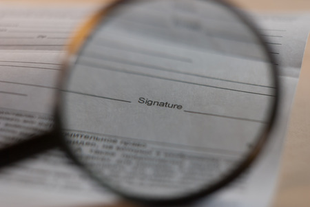 Sign here, under a magnifying glass,の写真素材