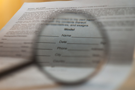 Document with empty fields under a magnifying glass,の写真素材