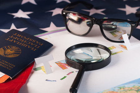 map and magnifier, planning travel, sunglasses, passport, American flag stencil from white paper, travelの写真素材