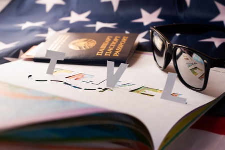 Atlas, sunglasses, American flag stencil from the paper. The concept of travel in America a Vacation in North America, world mapの写真素材