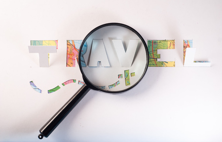 map and magnifier, journey planning, a stencil from white paper, travelの写真素材
