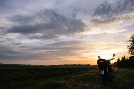 classic motorcycle on a sunset background, scenic landscape, travel by motorcycleの写真素材