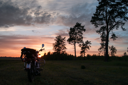 classic motorcycle on a sunset background, scenic landscape, travel by motorcycleの写真素材
