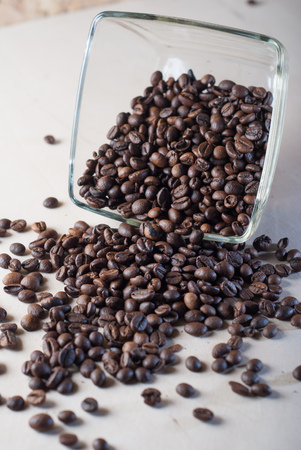 Coffee beans scattered on the table, upside-down glass bowl,の写真素材
