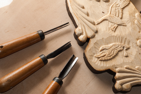 Tools for wood carving. Board with patterns.の写真素材