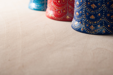 Decorative bell handmade ceramics, colorful Souvenirs from clay and hand painted, on wooden backgroundの写真素材