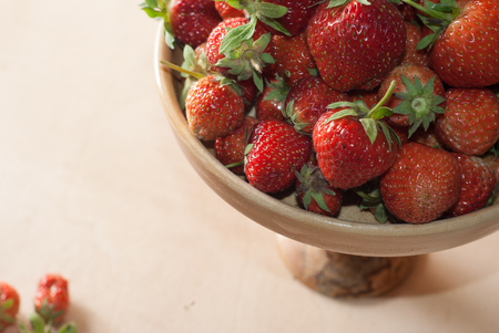Fresh strawberries in wooden kitchenware, wooden background,の写真素材