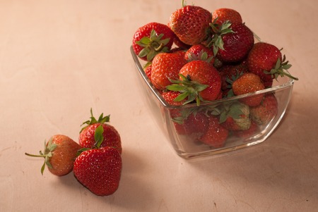 Ripe strawberries in a glass container, wooden background freshly picked berryの写真素材