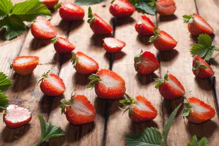 strawberry template on wooden background, rustic style, red berry and foliageの写真素材