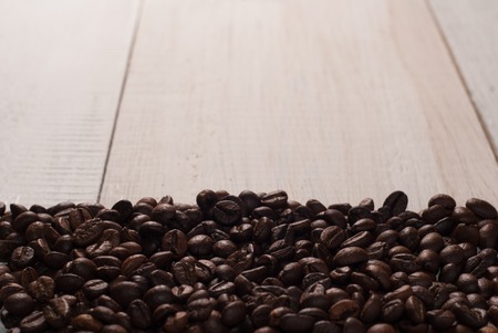 Coffee beans on wood backgroundの写真素材