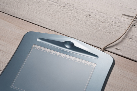 Graphics tablet on wooden background, rustic styleの写真素材