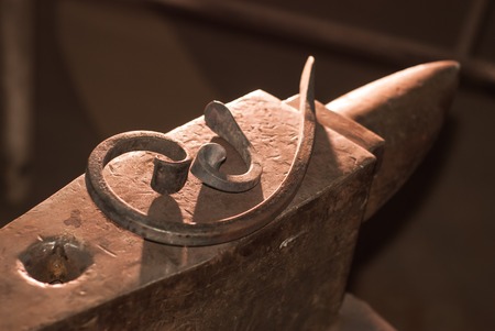 iron billet on the anvil, forged partsの写真素材