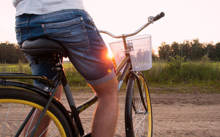 Stylish guy on a bike at sunset, leisureの写真素材