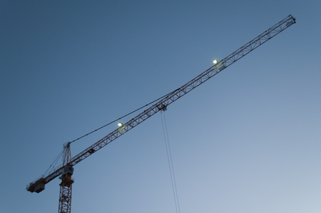 Tower crane against the sky, jib crane, view from belowの写真素材
