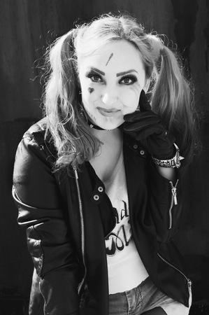 Cute girl harlequin, the image of a hot and dangerous girls posing on camera, emotional portraitの写真素材