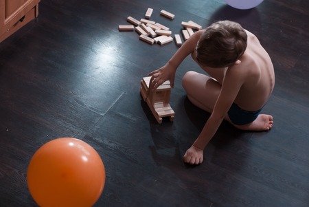 Boy Building a Structure from Wooden Building Blocksの写真素材