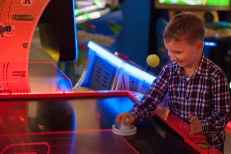 happy child playing table hockey, an emotional boyの写真素材