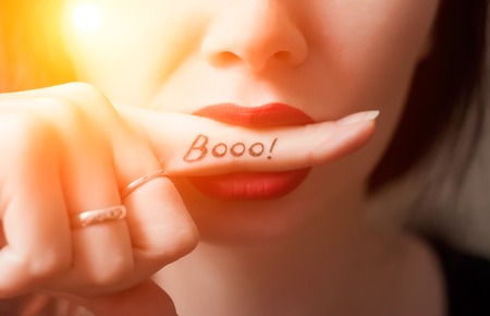 Girl closeup. the inscription on the finger, Booo. a concept banner for Halloweenの写真素材