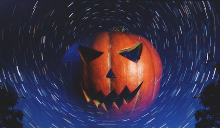 Jack-o ' - lantern on starry background, with a scary pumpkin for Halloweenの写真素材