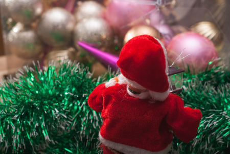 Happy Santa Claus Doll on Christmas time, tinsel and balls, festive background,の写真素材