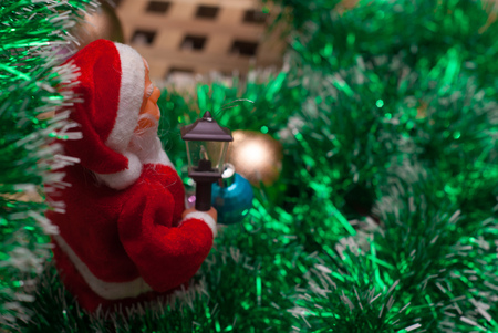 Happy Santa Claus Doll on Christmas time, tinsel and balls, festive background,の写真素材
