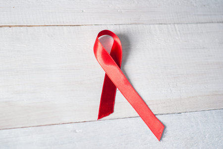 Day of struggle against AIDS. red ribbon on wooden white backgroundの写真素材