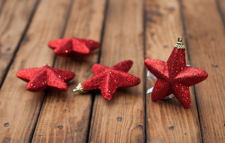 Christmas decorations.Red Christmas star on a rustic dark wooden backgroundの写真素材