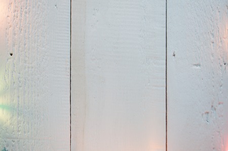 shabby white painted wood texture as the background, Christmas background with lights garlandsの写真素材