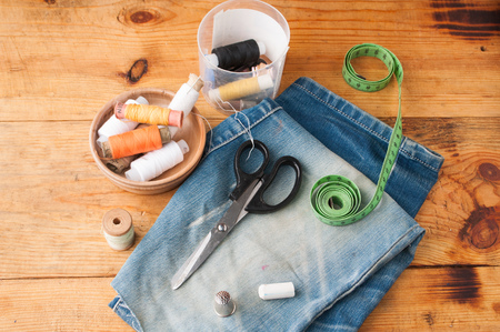 Sewing tools hobby, set of tailor on a wooden table, spools of thread, a steel thimble, top viewの写真素材
