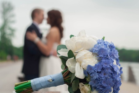 beautiful wedding bouquet on the background of newlyweds, wedding photoの写真素材