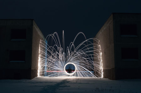Burning Steel Wool in the winter night, creative photography, sparks, sparks among the concrete
