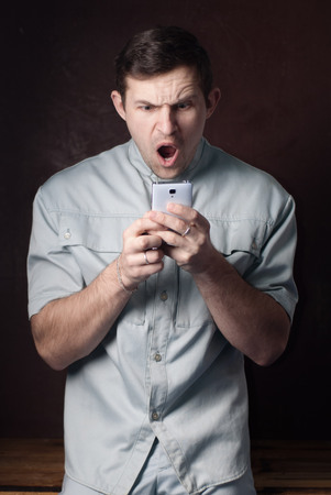 The young man was struck by the news from the Internet, shock content, the businessman learned about bankruptcy,の写真素材