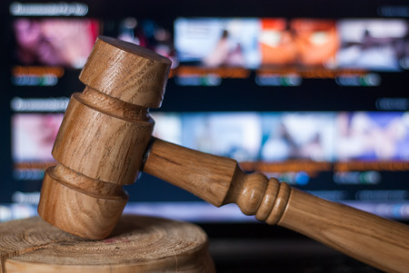 The gavel against the background of the laptop, illegal website with adult content, a court case in the manufacture and distribution of pornographic materialsの写真素材