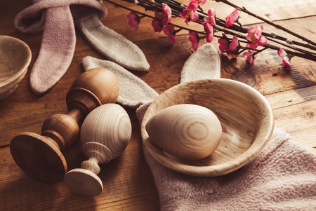 Wooden eggs, rabbit ears Easter symbol, Decorative eggs close-up, card template, Easter greetings, rustic styleの写真素材