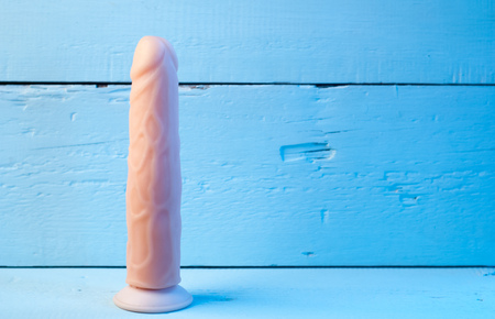 Realistic vibrator on a blue background, Showcase in a sex shop, toys for adultsの写真素材