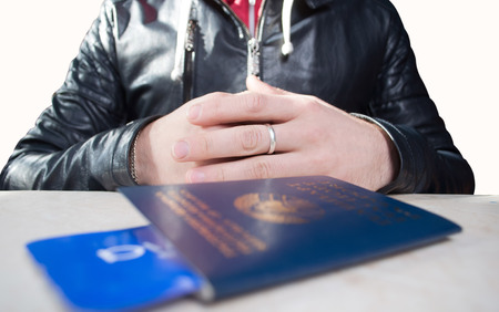 Ruka stretches her passport with a ticket, on a white background, the man without a face is check in on the flightの写真素材