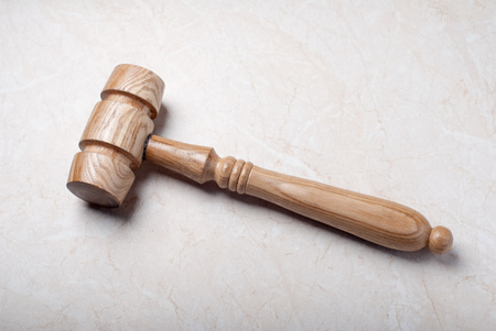 Wooden judges gavel on a marble background. trialの写真素材