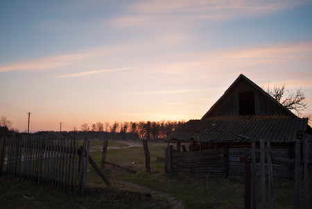 Dramatic sunset with old wooden barn in the countryside, abandoned old barnの写真素材