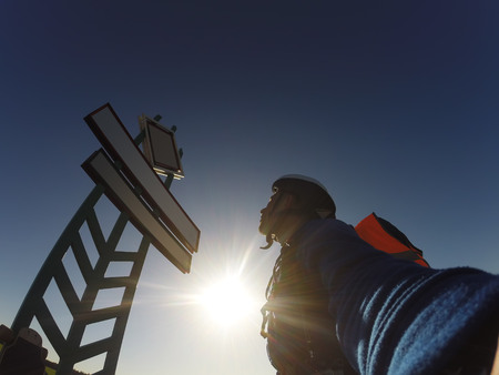 Rider looks at the sign, blue sky and bright sun,の写真素材