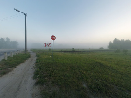Railway crossing, foggy morning,の写真素材