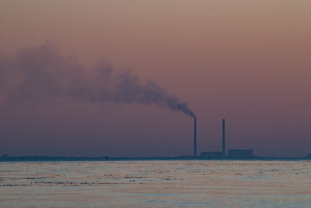 Smoke from the pipe at sunset, Power plant with huge smoke and electric towers in the distance, pollution concept,の写真素材