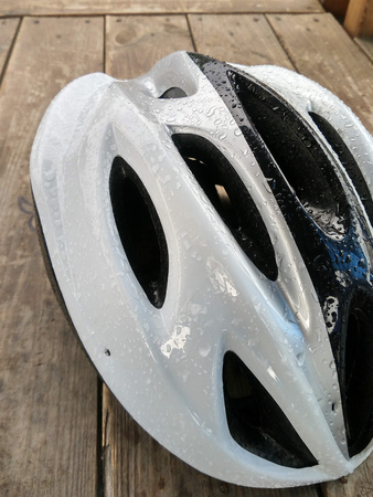 close-up of Bicycle mountain bike safety helmet, raindrops on Bicycle helmetの写真素材