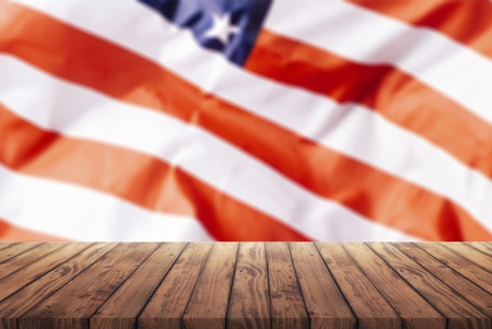 old wooden table for advertising goods on the background of the American flag, a template for the infographic of trade in the United States, a template for advertising goods from the United Statesの写真素材