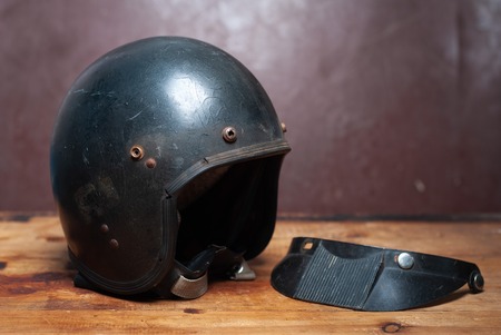 black vintage motorcycle helmet, classic helmet, old scratched helmetの写真素材