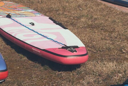 Walking paddle Board lying on grass, paddle Board for girl close up,の写真素材