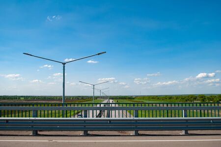paved road and blue sky. The path goes into the distance. Landscape on a bright Sunny dayの写真素材
