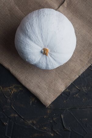 white pumpkin on the table top view. Autumn is a minimal concept.の写真素材