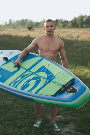 Paddle Board stand portrait. young surfer on outdoor,の写真素材