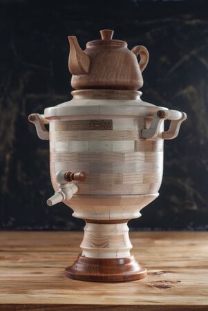 Wooden decorative samovar on a wooden table, rustic styleの写真素材