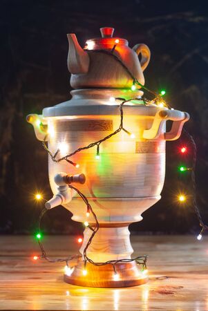 Christmas samovar and bright light garland. The concept of Russian folk traditionsの写真素材